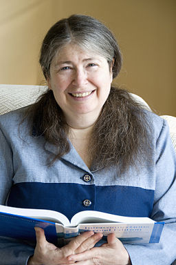 hoto of Radia Perlman, smiling an holding and open book in her hands